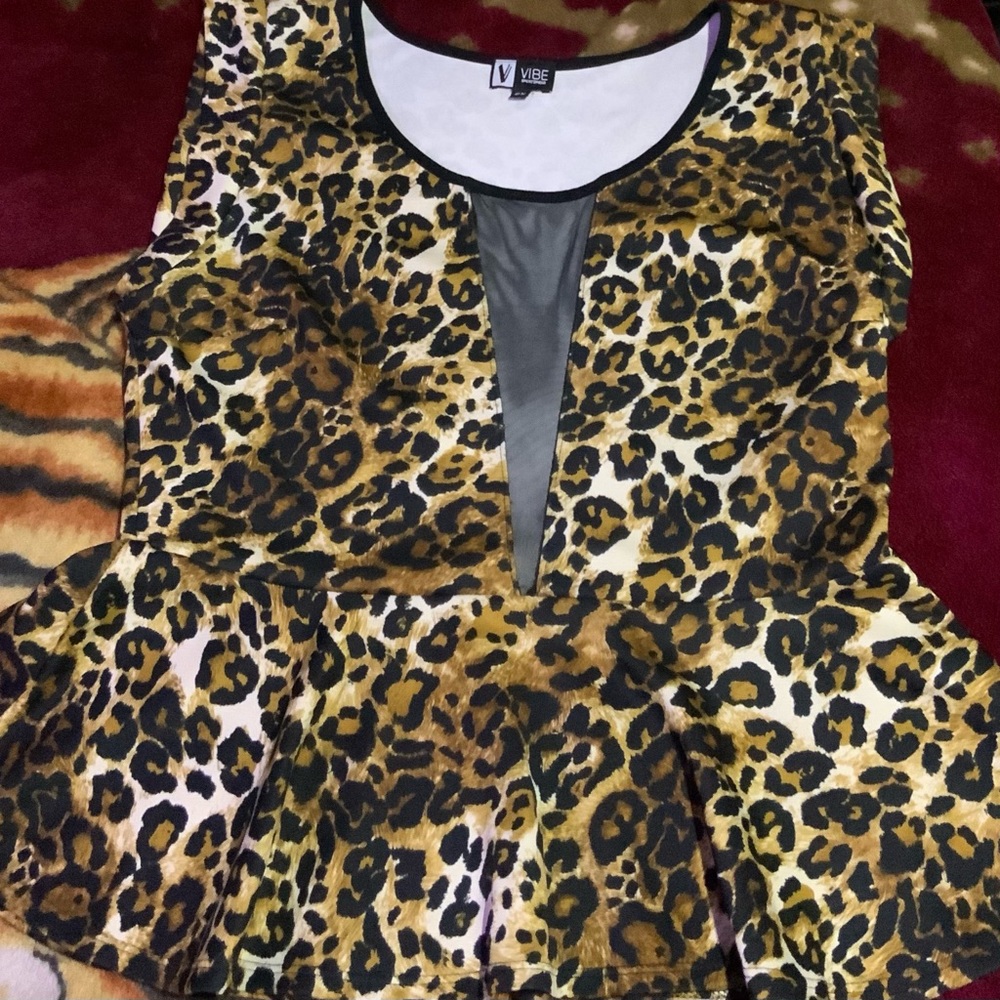 Fit and Flair Cheetah print blouse with a peek a boo section in the front.